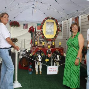 Imperio Mariense De Saugus officials, shown from left to right: President Walter Sousa, Vice President Filomena Fitch, Treasurer Isaura Disciullo and Secretary Madison Fitch by the cow carriage.