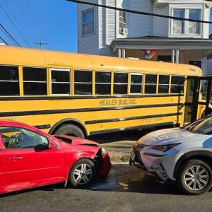 A school bus carrying 18 Malden Catholic students crashed into two passenger cars and careened up onto the lawn of a Highland Avenue home on Wednesday morning. No students were injured in the crash; the drivers of the two passenger vehicles were reportedly treated for injuries sustained in the crash. (Courtesy/Malden Fire Department)