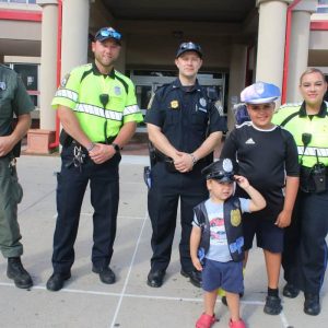 Shown from left to right: Massachusetts Environmental Police Officer Matthew Kohler, Revere Police Officer John Papasodora, Revere Police Officer Kenan Resic, “Det.” Jackson Chiulli, 3, and Dominic Chiulli, 9, and Revere Police Officer Raisa Builes played detective with the Chiulli family, fourth from left.