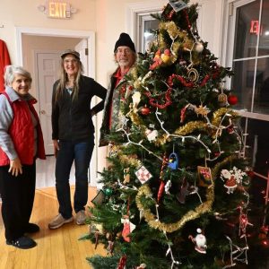Dolores Venetsanakos, Joanie Allbee and Paul Kenworthy help decorate the Saugus Historical Society Christmas tree in the bay window at 30 Main St. in Saugus. (Photo courtesy of Laura Eisener)