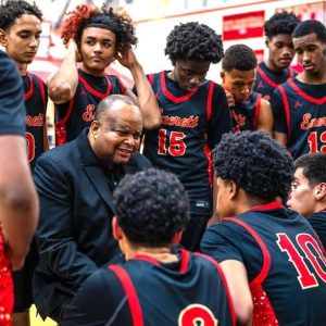 Everett Boys Basketball Head Coach Gerry Boyce talked to the team during a timeout in a season-opening win over Malden. (Advocate Photo/Henry Huang)