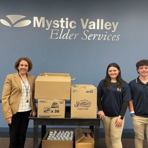 Malden Catholic junior Amelia Ferringo and classmate Ben Gowrie are pictured here delivering some donations to MVES CEO Lisa Gurgone. (Photo courtesy of MVES)