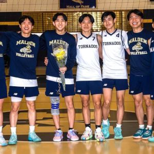 Eric Mei (center) with brother, Edward Mei and teammates