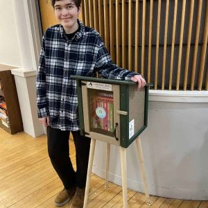 Evelyn Gayhart is shown with one of her Little Free Libraries.