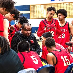 Everett Boys Basketball Head Coach Gerry Boyce talked to the team during a timeout in a season-opening win over Malden. (Advocate Photo/Henry Huang)