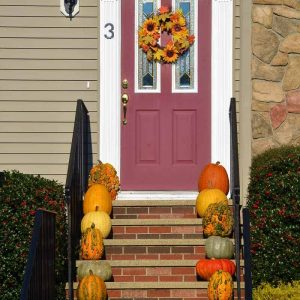 FALL SHOWCASE An assortment of interesting pumpkins including _Warty Goblin_ line the front steps at the home of Betty Couture in Lynnhurst