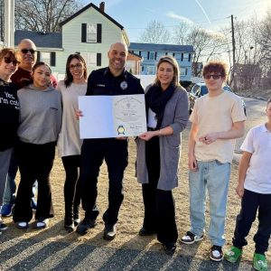 State Representative Jessica Giannino is shown with Officer JJ Jones and his family with his citation from the House of Representatives in honor of Black History Month. (Courtesy State Rep. Giannino’s Office)