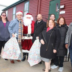 SPIRIT OF GIVING: Shown at right, Associate Pastor Joel Varghese, Nursery Director Nicolette, Loralei Loranzo and Pastor Tim Bogertman accepted donations on behalf of First Congregational Church. Shown at left, Business Representative Hector Rivera, of the North Atlantic States Regional Council of Carpenters Union. (Advocate photo by Tara Vocino)