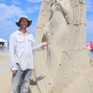 LAST YEAR’S WINNER: Hailing from Canada, Abe Waterman won first place for “The Devil Is An Angel, Too” in the 2023 Revere Beach International Sand Sculpting Competition. (Advocate file photo)