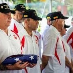 Former Saigon Marine Security Guard and current Malden resident John Ghilain holding flag at the American Consulate in Ho Chi Minh City, Vietnam in 2015. (Photo courtesy of Veterans Services’ Officer Kevin Jarvis)