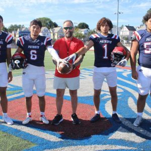 TEAM LEADERS: Ready to lead the Patriots to victory on Turkey Day are Revere’s Captains, shown from left to right: Danny Hou, Darian Martinez, Head Coach Louis Cicatelli, Geo Woodward and Adam Lemus.