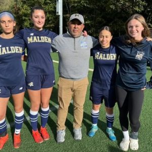 Malden High Girls Soccer Head Coach Rich Caceda and seniors Ayala Escobar, Maia Saeed, Valentina Hernandez Lemus and Makenzie Jenkins. Not shown: Jazlyn Martinez. (Courtesy Photo/Malden Athletics)