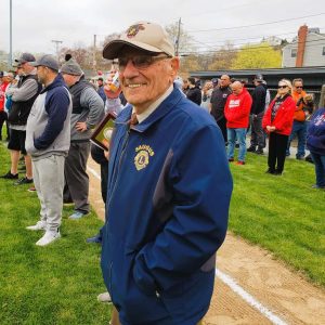 GRAND MARSHAL: Eugene Decareau, 95, the oldest-living former baseball coach of the Saugus Little League, joins league officials at last year’s Opening Day Ceremonies. He will be leading the parade again this year, but with a different route. (Saugus Advocate file photo by Mark E. Vogler)
