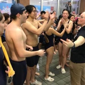 GREAT JOB! Malden High swim Head Coach Jess Bisson congratulated the team after the GBL title-clinching meet win over Revere. (Advocate Photo)