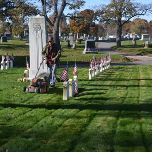 Gordon Shepard mows the lawn at the veterans’ plot for the final time of the season. (Photo courtesy of Laura Eisener)