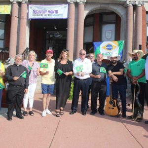 Shown from left to right: volunteer Angelita Oliveira; Fr. Marcio Calais, FDP - Madonna Queen of Universe Shrine - East Boston; City Council President Pro Tempore/Ward 1 City Councillor Joanne McKenna, Ward 2 City Councillor Ira Novoselsky, State Representative Jessica Giannino, School Committee Member John Kingston, School Committee Member candidate Ralph DeCicco, Northeast Metro Tech School Committee Member/Revere School Committee Member candidate Anthony Caggiano, Marcelo Mota, of Cowboy De Rondonia; State Representative Jeffrey Turco and Acting Mayor Patrick Keefe, Jr.