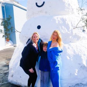 HANGING OUT WITH FROSTY: Saugus Youth and Recreation Director Crystal Cakounes, her seven-year-old son Brackett and her niece Natalia Daniels enjoyed their time with the giant snowman that appeared on Main Street on Tuesday. (Courtesy photo of Rick Fail)