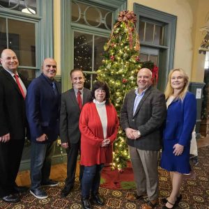 HAPPY NEW YEAR FROM SAUGUS: The Saugus Board of Selectmen and Town Manager Scott C. Crabtree gathered around the Christmas tree on the first floor of Saugus Town Hall earlier this month. Sharing their holiday hopes and best wishes to town residents for a happy new year, were – pictured from left to right – Town Manager Scott C. Crabtree, Selectman Anthony Cogliano, Selectman Mike Serino, Selectman Corinne Riley, Board of Selectmen Vice Chair Jeffrey Cicolini and Board of Selectmen Chair Debra Panetta. (Saugus Advocate photo by Mark E. Vogler)
