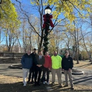 Mayor Gary Christenson and Ward 7 Councillor Christopher Simonelli are shown with members of the Malden Dept. of Public Works at Lincoln Commons after placing the lights on the Christmas tree recently.