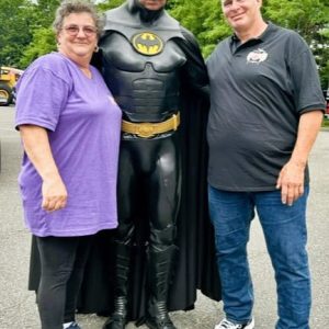Host and Hostess with Batman: Brenda and Guy Moley of Mom’s Cancer Fighting Angels took a moment to pose with Eddie Ardolino, who was dressed as Batman. (Photo Courtesy of Joanie Allbee)