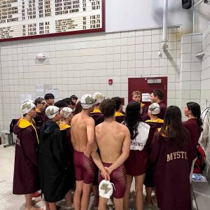 Coach Andrew DiGiacomo giving the team a pep talk before the meet.