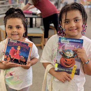 SISTERS WITH BRAIDS AND BOOKS: Amaya and Gianna Bradley, who are attending classes at Veterans Early Learning Center this fall, were both winners in the Summer Reading Program at the Saugus Public Library. (Courtesy photo of Amy Melton)