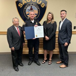 Saugus Police Chief Michael Ricciardelli is shown holding a Citation from the Massachusetts Senate; from left to right are State Representatives Donald Wong and Jessica Giannino and State Senator Brendan Crighton.