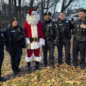 SAFETY SANTA: Santa Claus is shown with members of Malden’s Finest at the Christmas tree lighting.