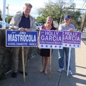 Shown from left to right: Joseph Fahey and Ward 4 School Committee member candidates James Mastrocola and Holly Garcia are shown outside of the Lafayette School on Tuesday.