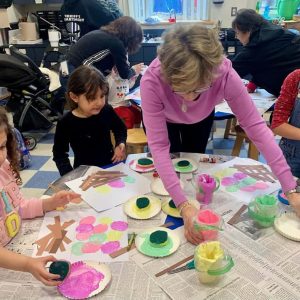 EASTER ART AT THE LIBRARY: Janice Nelson read Minerva Louise and the colorful Eggs by Janet Stoeke and also led an Easter Basket Craft to get the kids in the Easter spirit recently. Joining her are Saugus residents Marina Movico, 4, Tower Day School; Viya Patel, 7, Veterans Early Learning Center; and Emma Murray, 6, the Veterans Early Learning Center. (Courtesy Photo of Amy Melton, Head of Children’s Services at the Saugus Public Library)