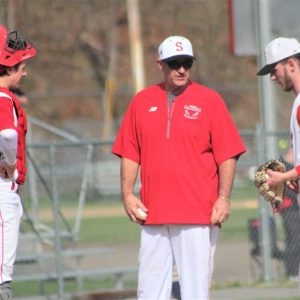 Saugus catcher Michael Howard, head coach Joe Luis and pitcher Sean O'Rourke meet on the mound in a game against Winthrop earlier this season. The Sachems were one victory away from possibly qualifying a postseason berth after Wednesday's win over Everett.