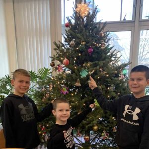 IN THE HOLIDAY SPIRIT: Saugus Public School students who recently visited the Saugus Public Library enjoyed the Christmas Tree on the second floor donated by Soc’s Ice Cream. Pictured from left to right are Belmonte STEAM Academy second-grader Anthony Smith, Veterans Early Learning Center preschooler Caden Keohane and Belmonte STEAM Academy second-grader Cody Keohane. (Courtesy photo of Amy Melton, Head of Children's Services at the Library)