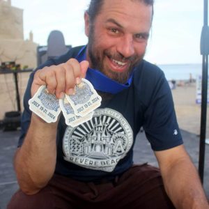 HE’S NUMBER ONE: Canadian sand sculptor Jobi Bouchard, shown at left with his winning medals, created “Blend In,” which won first place at the 20th Annual Revere Beach Sand Sculpting Competition on Saturday.  (Advocate photos by Tara Vocino)
