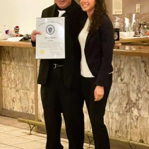 Saugus Democratic Town Committee Chair Joe Malone receives a citation from State Auditor Diana DiZoglio, recognizing him for his decades of professional work for the Commonwealth along with his decades of community service. (Courtesy photo to The Saugus Advocate)