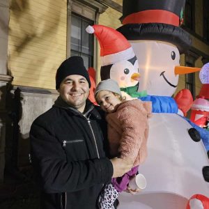 Joe Vecchione and his daughter Amelia, 3 ½, are shown near Frosty, the giant inflated snowman.