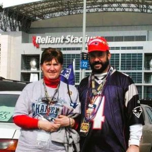 Joseph “Dennis” Gould, left, and his wife, Janice Gould, stand in front of Reliant Stadium in Houston, Tex. wearing New England Patriots attire on Feb. 1, 2004, during Super Bowl XXXVIII. (Courtesy photo of Joseph “Dennis” Gould to The Saugus Advocate)