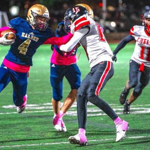 Josh Bly (4) gives a stiff arm to Chelsea defender Leandro Castro in the GBL matchup. (Advocate Photo/Henry Huang)