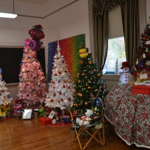 These are just a few of the trees on view at the MEG that some lucky raffle winners may be taking home next Sunday. The tabletop tree has decorations handmade by Saugus children at the public library. (Photo courtesy of Laura Eisener)