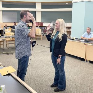 Kristin Bairos is shown being sworn-in as At-Large School Committee member by City Clerk Sergio Cornelio on Monday evening at the EHS Library. (Courtesy of EPS)