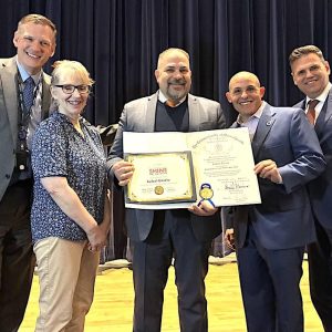Malden Linden STEAM Academy Principal Rafael “Ray” Garcia (third from right) displays a Mass. House “Latino Educators SHINE 2025” Award he received at the Mass. State House. It was presented by Malden state Rep. Steven Ultrino (D-33rd Middlesex, right). On hand supporting Principal Garcia at the presentation were Malden Mayor and School Committee Chairperson Gary Christenson (at right), Malden Superintendent of Schools Timothy Sippel, Ed.L.D. (at left) and Ward 8 School Committee member Sharyn Rose-Zeiberg. (Courtesy/Office of Mayor Gary Christenson)