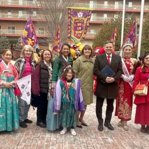 Pictured with parade attendees (from left): Police Chief Glenn Cronin, Ward 8 School Committee member Sharyn Rose-Zeiberg (third from left), Councillor-at-Large Michelle Luong (fourth from left), Middlesex County District Attorney Marian Ryan (next to mayor), Mayor Gary Christenson (red tie) and Ward 3 Councillor Amanda Linehan (far right).