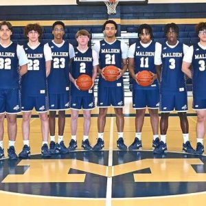 MALDEN HIGH TEAM: The 2025-2026 Malden High School Varsity Boys Basketball Team includes, from left, Assistant Coach John McGlynn, Nguyen Sy, Alan Deris, Mario Joseph, Daniel Ferreira, Jason Minervini, Jaheim Rene, senior captain Ryan McMahon, senior captain Kaua Fernandes Dias Valadares, senior captain Colin Okoth, Shawn Sekamwa, Shao Zhang, David Kintu, senior Chace Bolling, Varsity Head Coach Don Nally and Assistant Coach Dan Jurkowski. (All Photos Courtesy/MHS Yearbook/The Maldonian)
