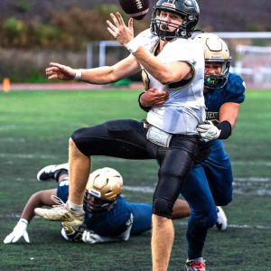 #4
Northeast quarterback Ryan Beede (8) is in the grasp and sacked by Malden’s Jonathan Ventura (56). (All Advocate Photos/Henry Huang)