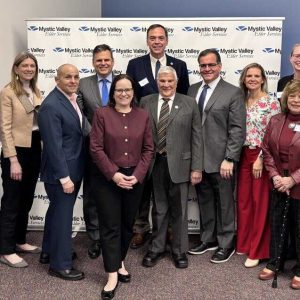 From left to right: District Director Em Sheeran of the Office of State Senator Jason Lewis, State Representatives Richard Haggerty, Kate Lipper Garabedian and Steve Ultrino, Malden Mayor Gary Christenson, Melrose Mayor Jennifer Grigoraitis, State Representatives Jeffrey Turco and Paul Donato, Everett Mayor Robert Van Campen, Medford Mayor Breanna Lungo Koehn, Senior District Director Mary Ann Nay of State Senator Bruce Tarr’s office, State Representative Christine Barber, North Reading Town Administrator Michael Gilleberto and Mystic Valley CEO Lisa Gurgone.