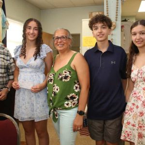 Maeve Hurley received a check from Grand Knight Robert Alessi (far left). Shown are family members, her mother, Marisa, her brother, Michael and her sister, Caitlyn.