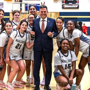 The Malden High School Girls Basketball Team earned a big Greater Boston League victory over visiting Everett, 44-28. On hand for the win was Malden Mayor Gary Christenson (center). Celebrating with the Mayor for Malden High were, from left, Aaliyah Ferreira, Ivana Marinkovic, Olivia Rodrigues, Maddy Cook, Sophia Rodrigues, captain Amanda Ebenezer, Ina Tolete, Janesa Perez Sims, Jazzhy Antoine, Manicha Exilhomme and captain Kim Tropnas. The Head Coach is Scott Marino. The story and many more photos are inside. (Advocate Photo/Henry Huang)