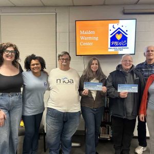 Lisa Alan, of Melrose, and Christine Lane, of Medford, presented Cummings Community Giving donations to the team at the Malden Warming Center. (Courtesy photo)