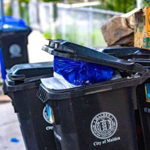 Trash and recycle bins on Stearns Street in Malden not being collected due to the trash collectors strike. (Jesse Costa/WBUR)