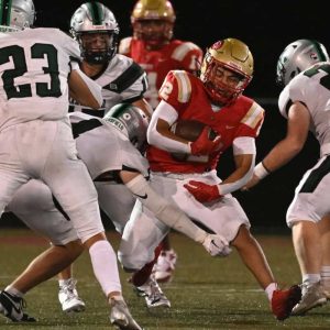 Tide’s Manny Santiago crashes through Mansfield defenders.