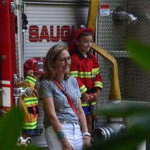 Mateo Figueroa, 2, and his brother Caleb Figueroa, 5, were dressed just right to take in the Firemen’s program at the Saugus Iron Works National Historic Site. Saugus Children’s Librarian Amy Melton (foreground) arranged the story-time program. (Photo courtesy of Laura Eisener)